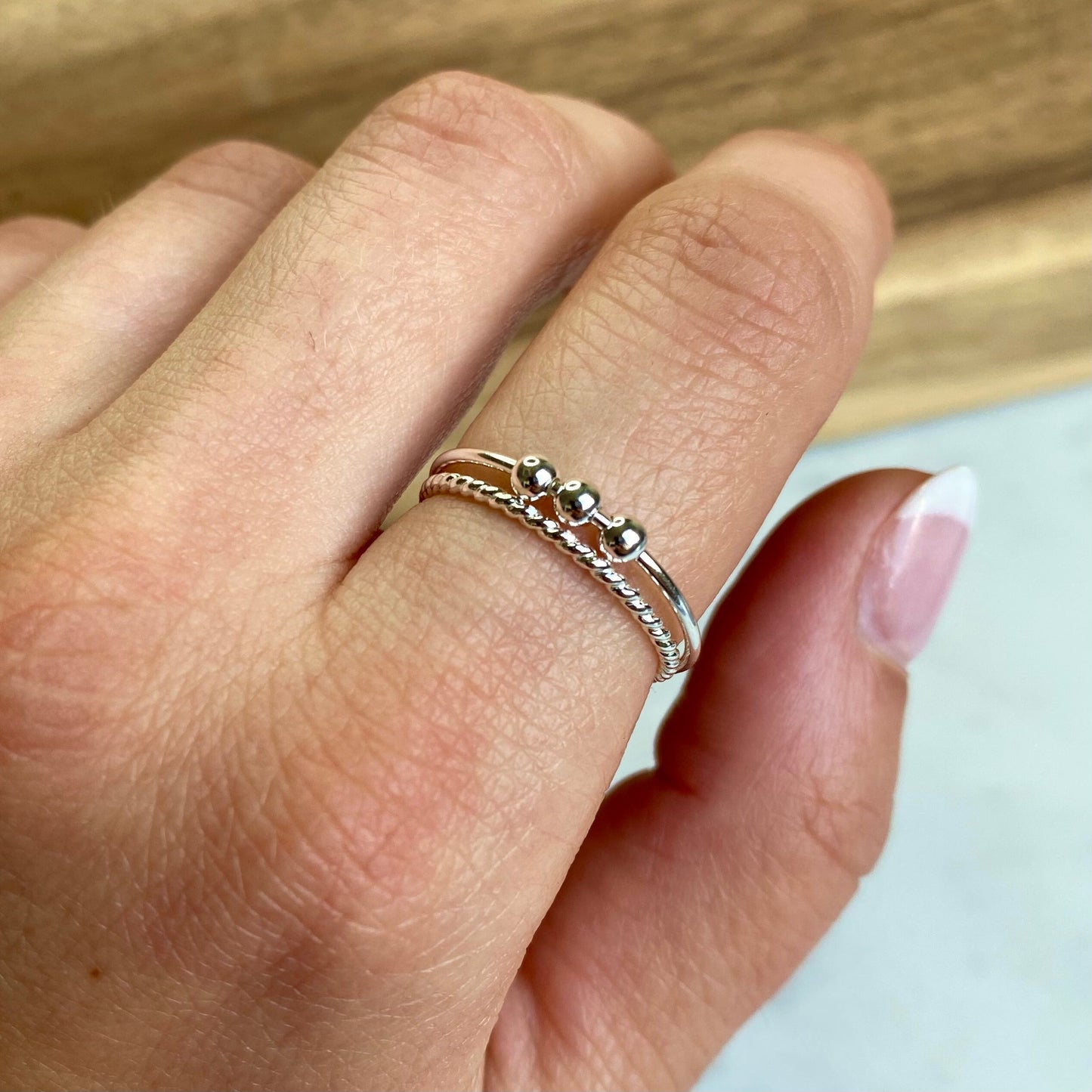Silver Fidget Anxiety Bead ring stacked with rope stacking ring