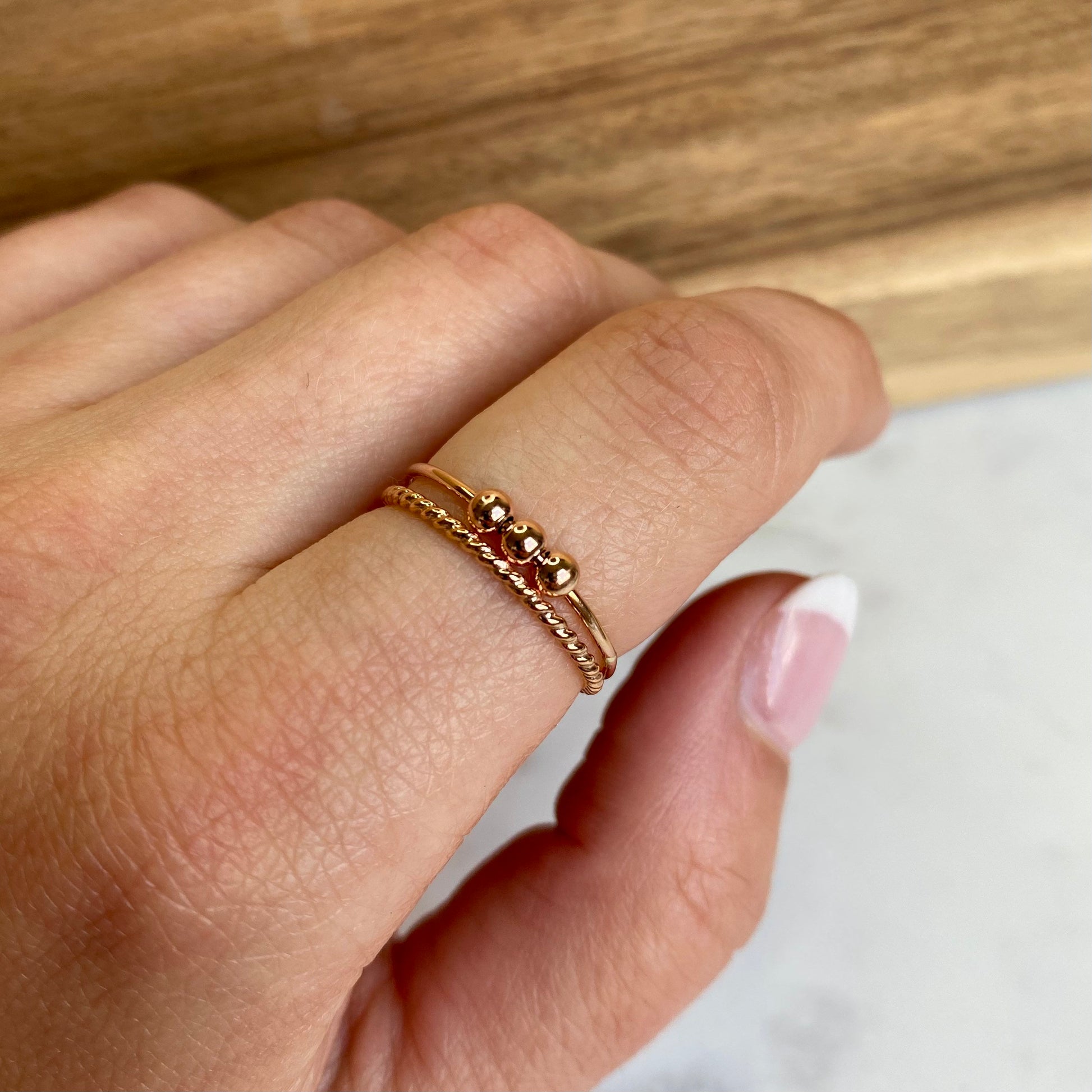 Rose Gold Fidget Anxiety Bead ring stacked with rope stacking ring